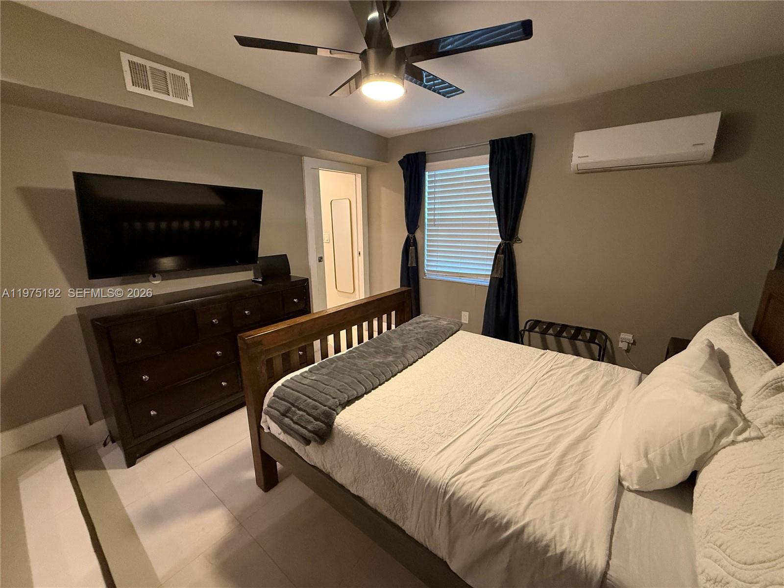 4850 Southwest 4th Street Miami, FL 33134 - Photo 12 of 28 a bedroom with a bed and a flat screen tv