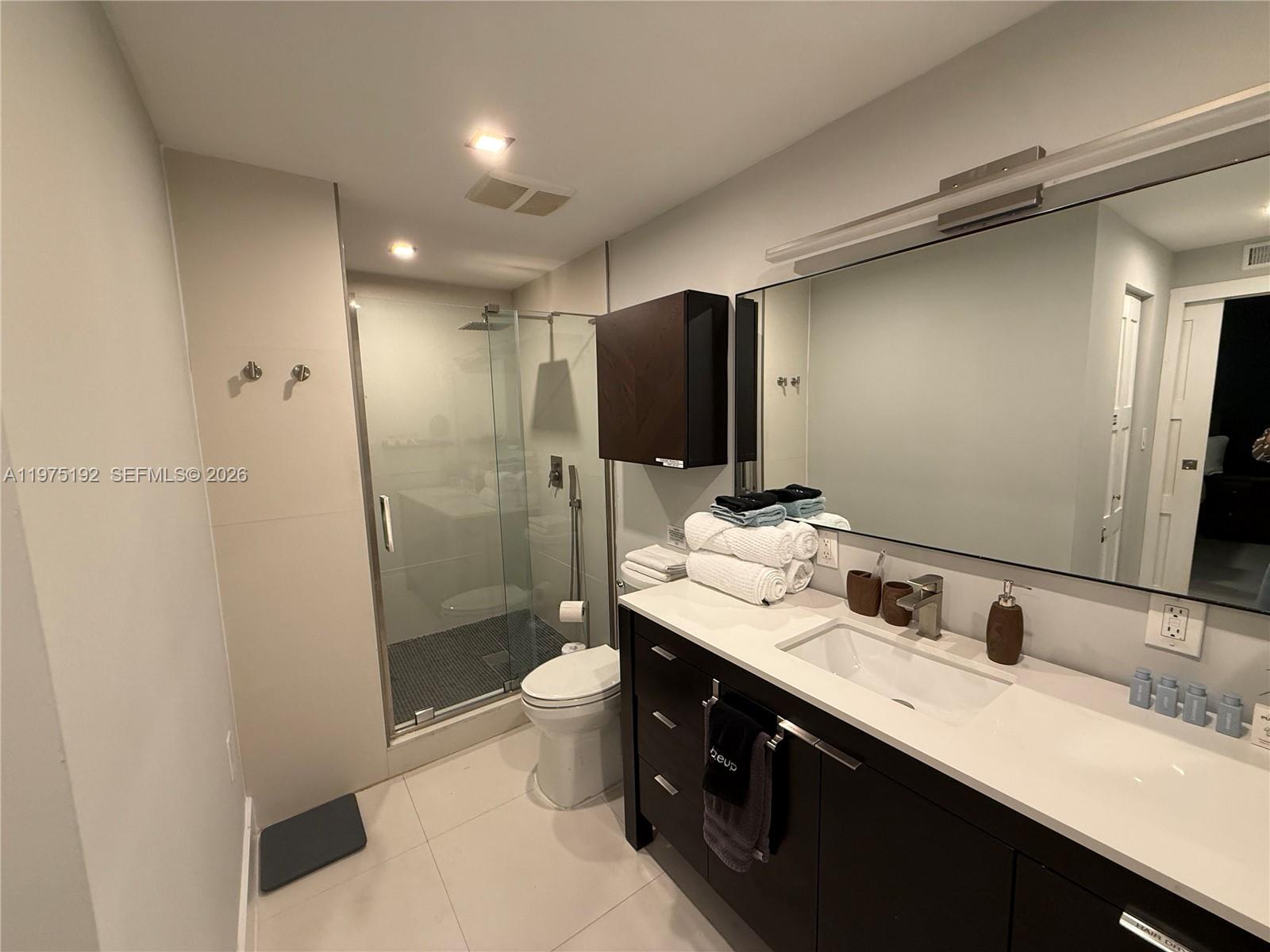 4850 Southwest 4th Street Miami, FL 33134 - Photo 13 of 28 a bathroom with a double vanity sink toilet and shower