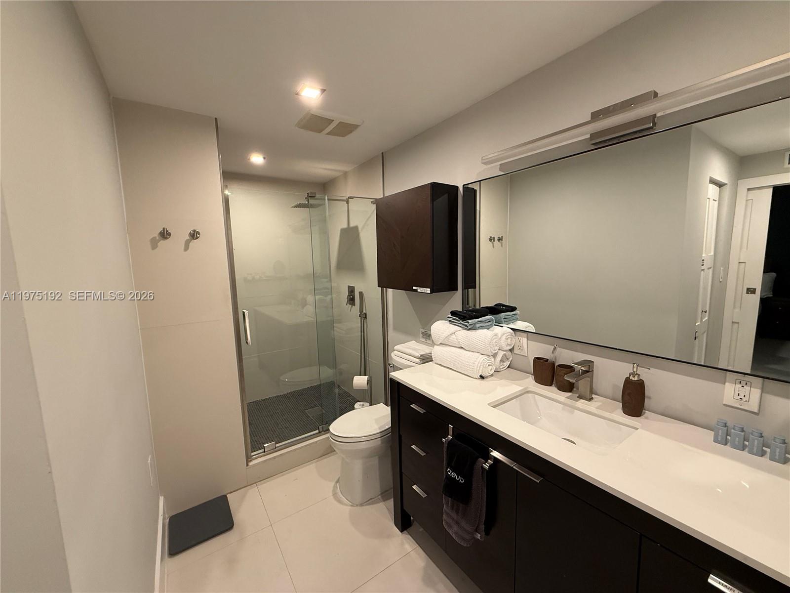4850 Southwest 4th Street Miami, FL 33134 - Photo 14 of 28 a bathroom with a double vanity sink toilet and shower