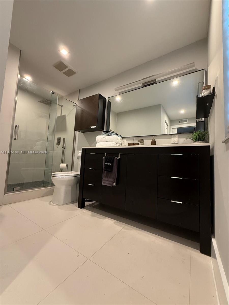4850 Southwest 4th Street Miami, FL 33134 - Photo 15 of 28 a bathroom with a sink and a mirror