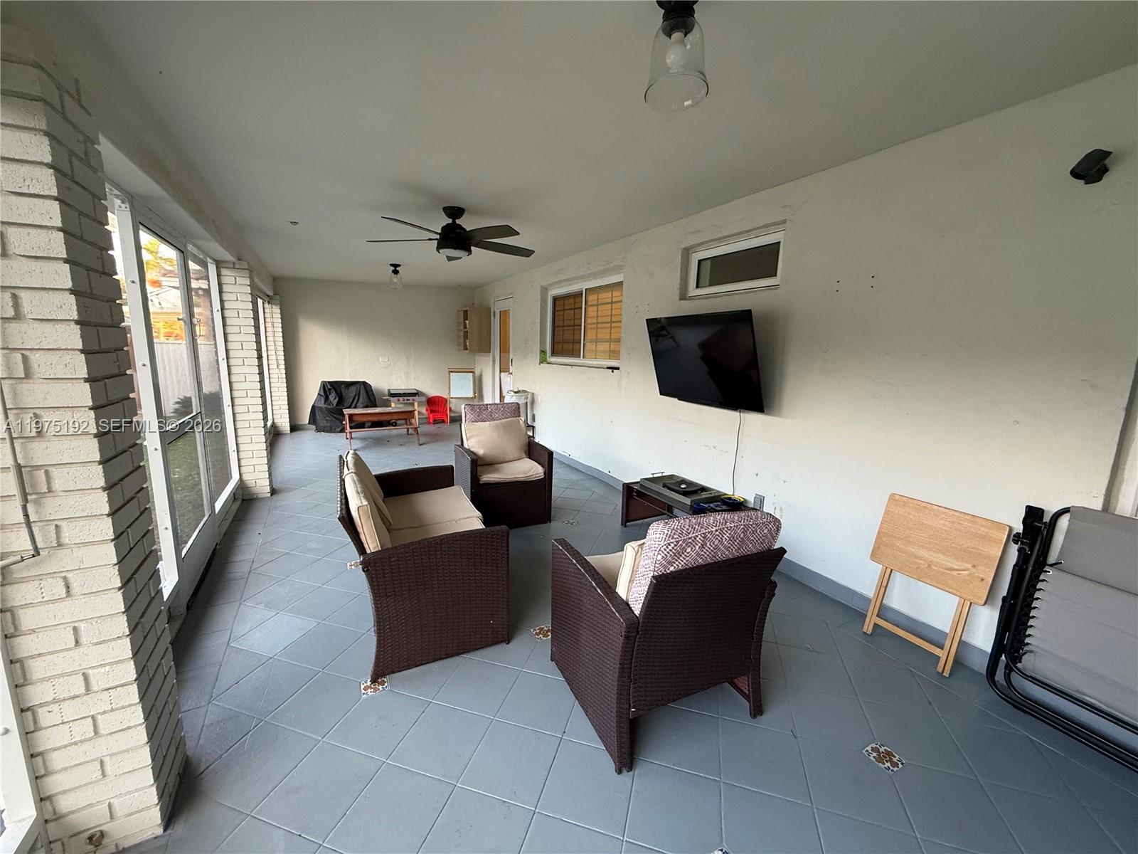 4850 Southwest 4th Street Miami, FL 33134 - Photo 17 of 28 a living room with furniture and a flat screen tv