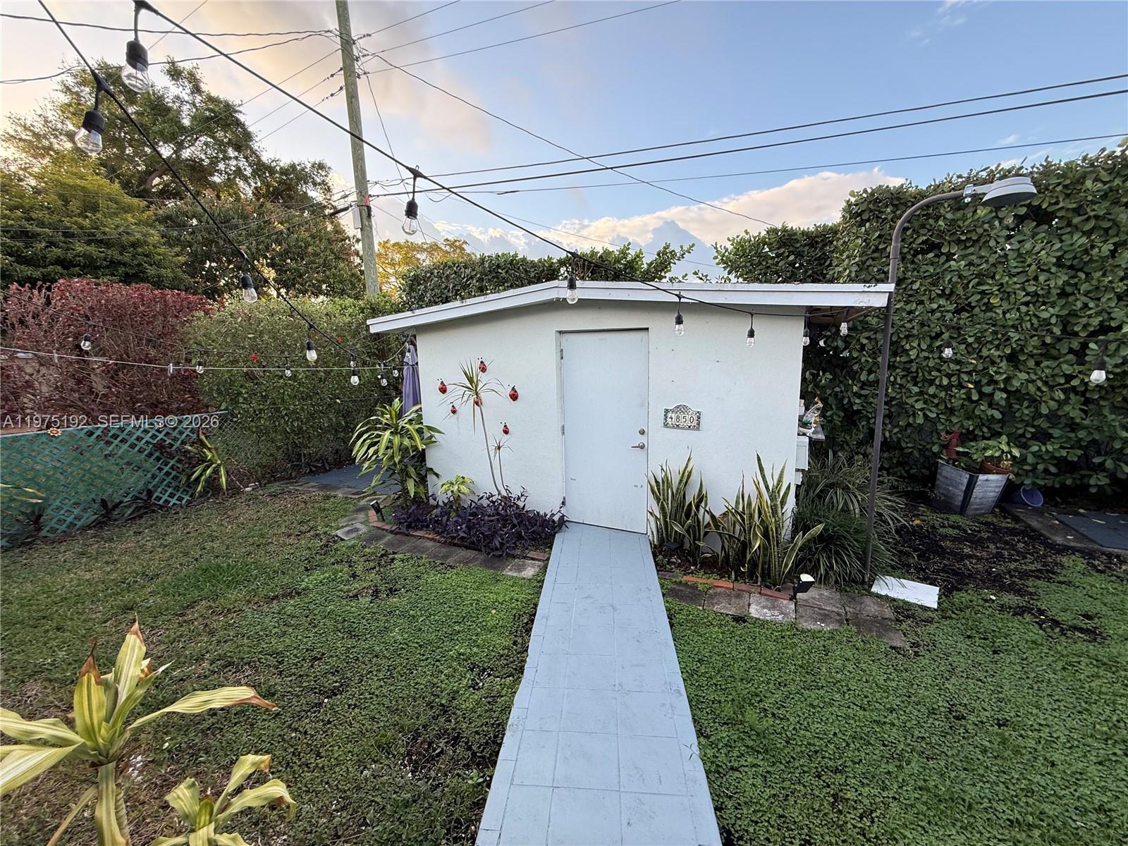 4850 Southwest 4th Street Miami, FL 33134 - Photo 18 of 28 a backyard of a house with lots of green space