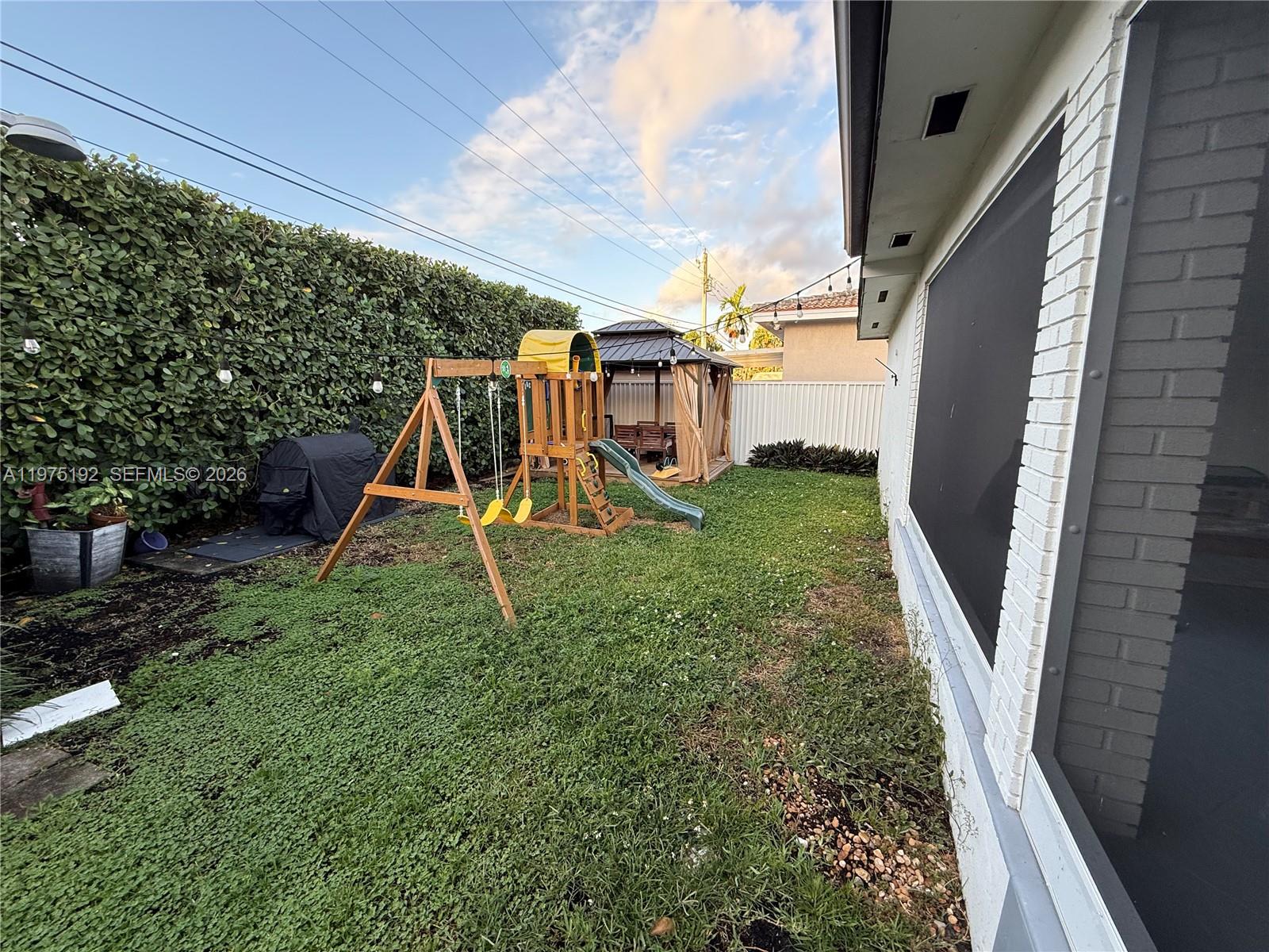 4850 Southwest 4th Street Miami, FL 33134 - Photo 19 of 28 a view of a backyard with plants and a slide