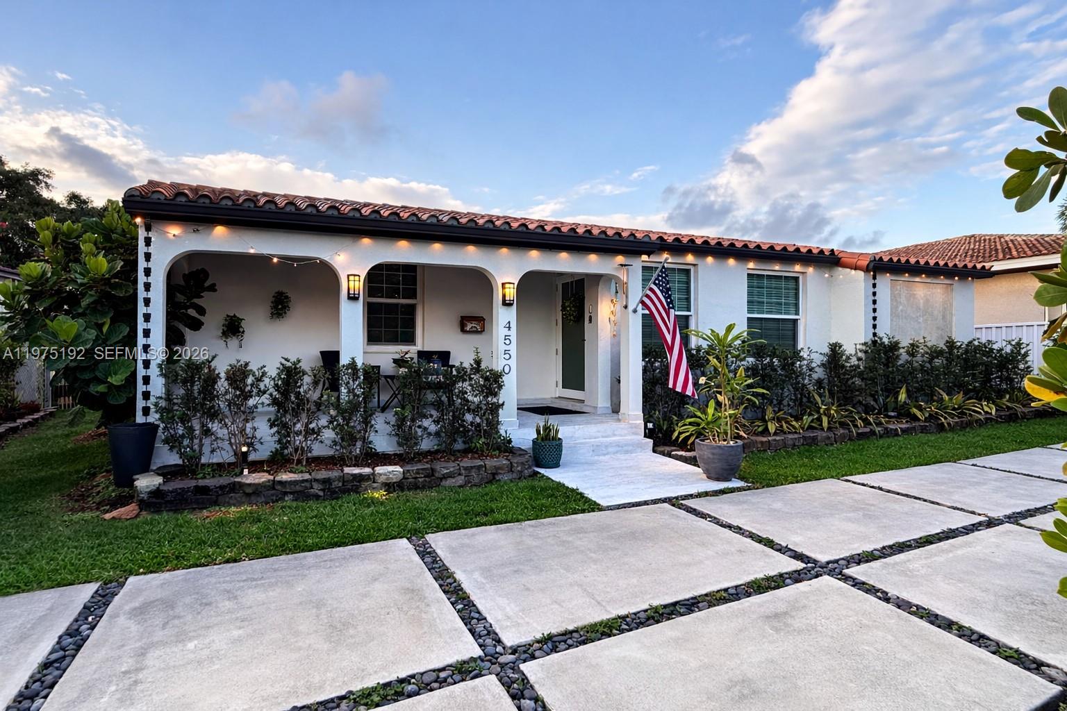 4850 Southwest 4th Street Miami, FL 33134 - Photo 2 of 28 a front view of a house with garden