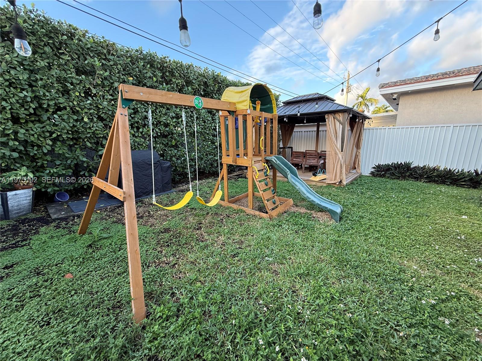4850 Southwest 4th Street Miami, FL 33134 - Photo 21 of 28 a view of a backyard with a table and chairs