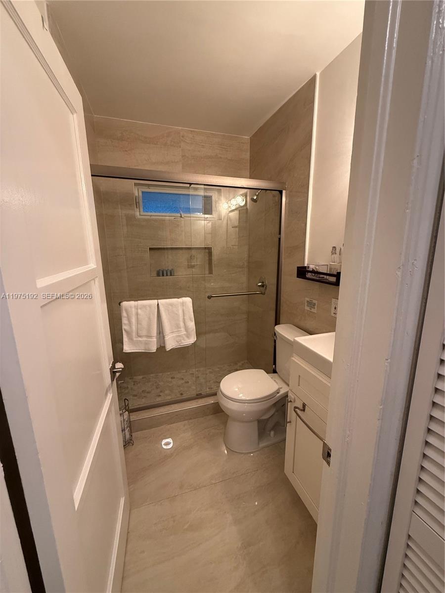 4850 Southwest 4th Street Miami, FL 33134 - Photo 23 of 28 a bathroom with a toilet and a shower