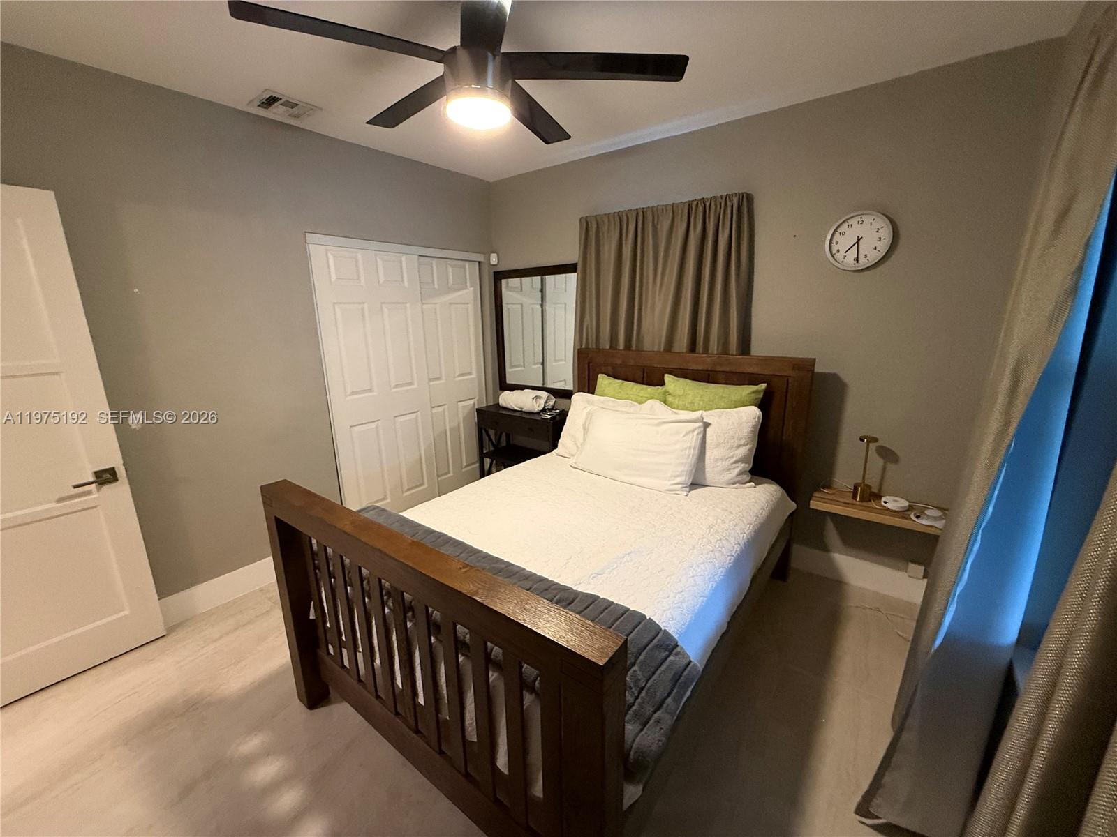 4850 Southwest 4th Street Miami, FL 33134 - Photo 26 of 28 a bedroom with a bed and a chandelier