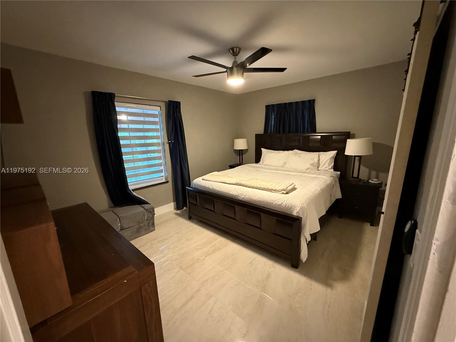 4850 Southwest 4th Street Miami, FL 33134 - Photo 27 of 28 a bedroom with a bed and a chandelier