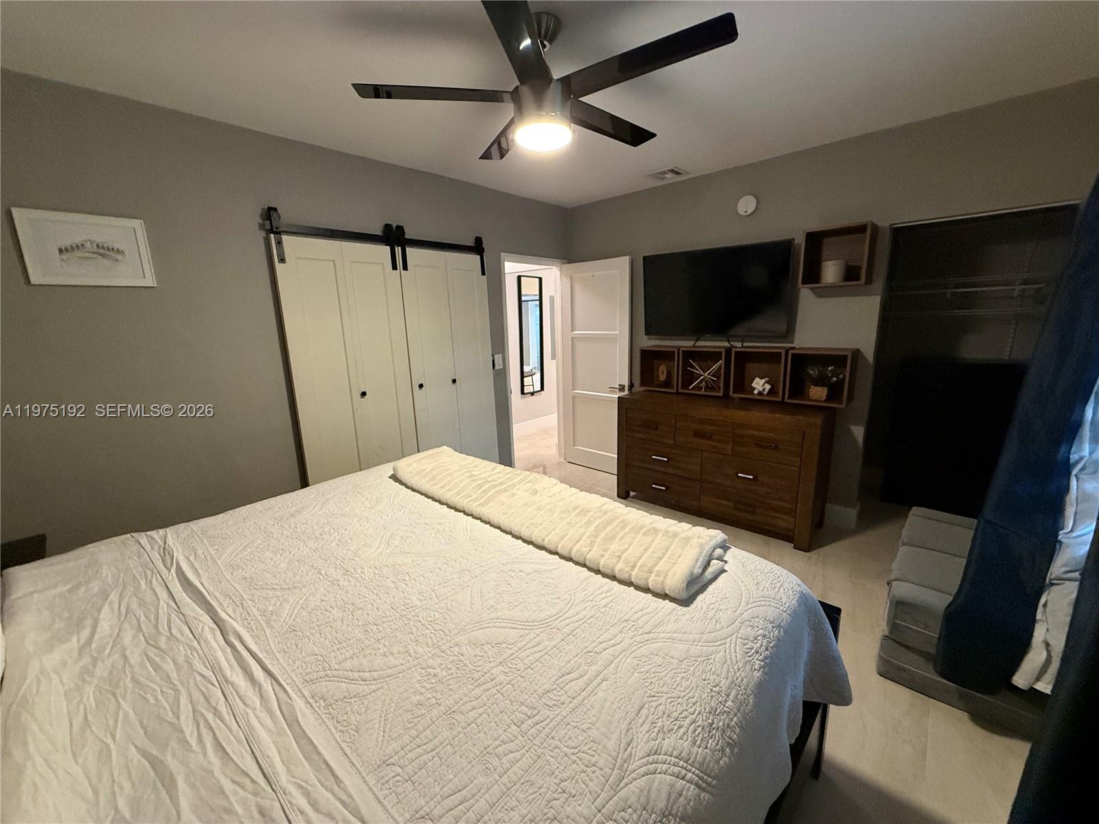 4850 Southwest 4th Street Miami, FL 33134 - Photo 28 of 28 a bedroom with a bed and a flat screen tv