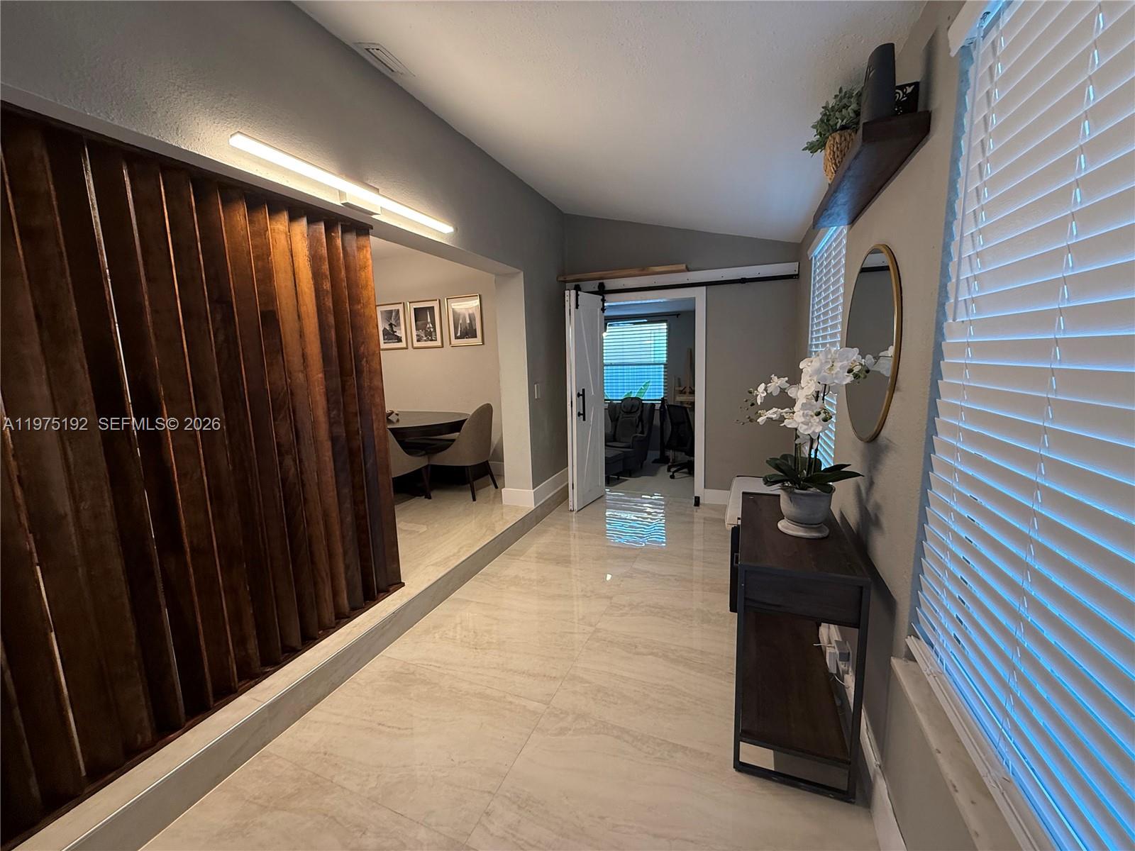 4850 Southwest 4th Street Miami, FL 33134 - Photo 3 of 28 a living room with furniture and a chandelier