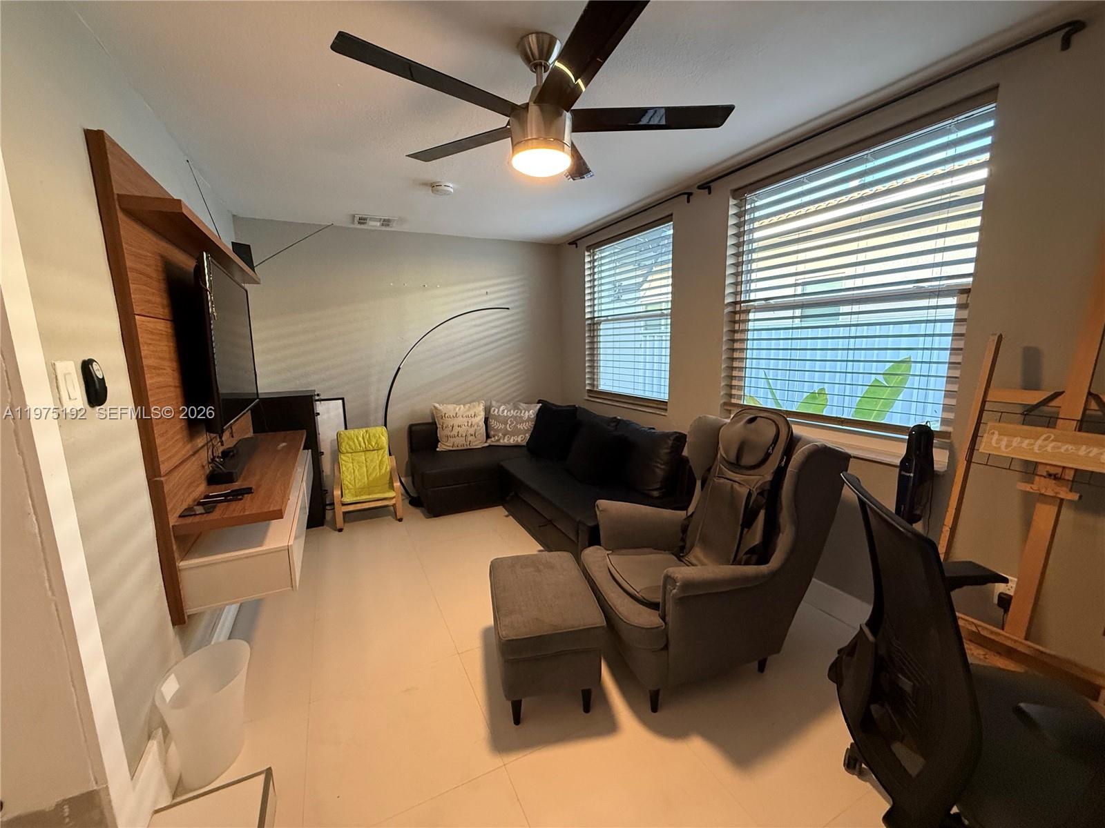 4850 Southwest 4th Street Miami, FL 33134 - Photo 5 of 28 a living room with furniture a window and a ceiling fan