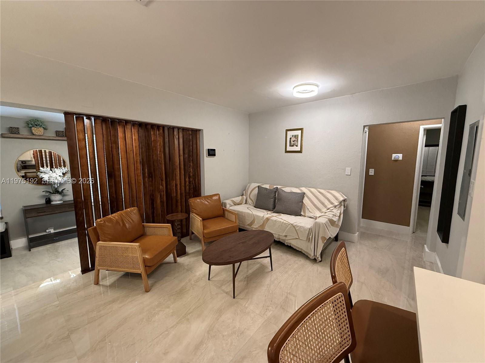 4850 Southwest 4th Street Miami, FL 33134 - Photo 7 of 28 a living room with furniture and a chair