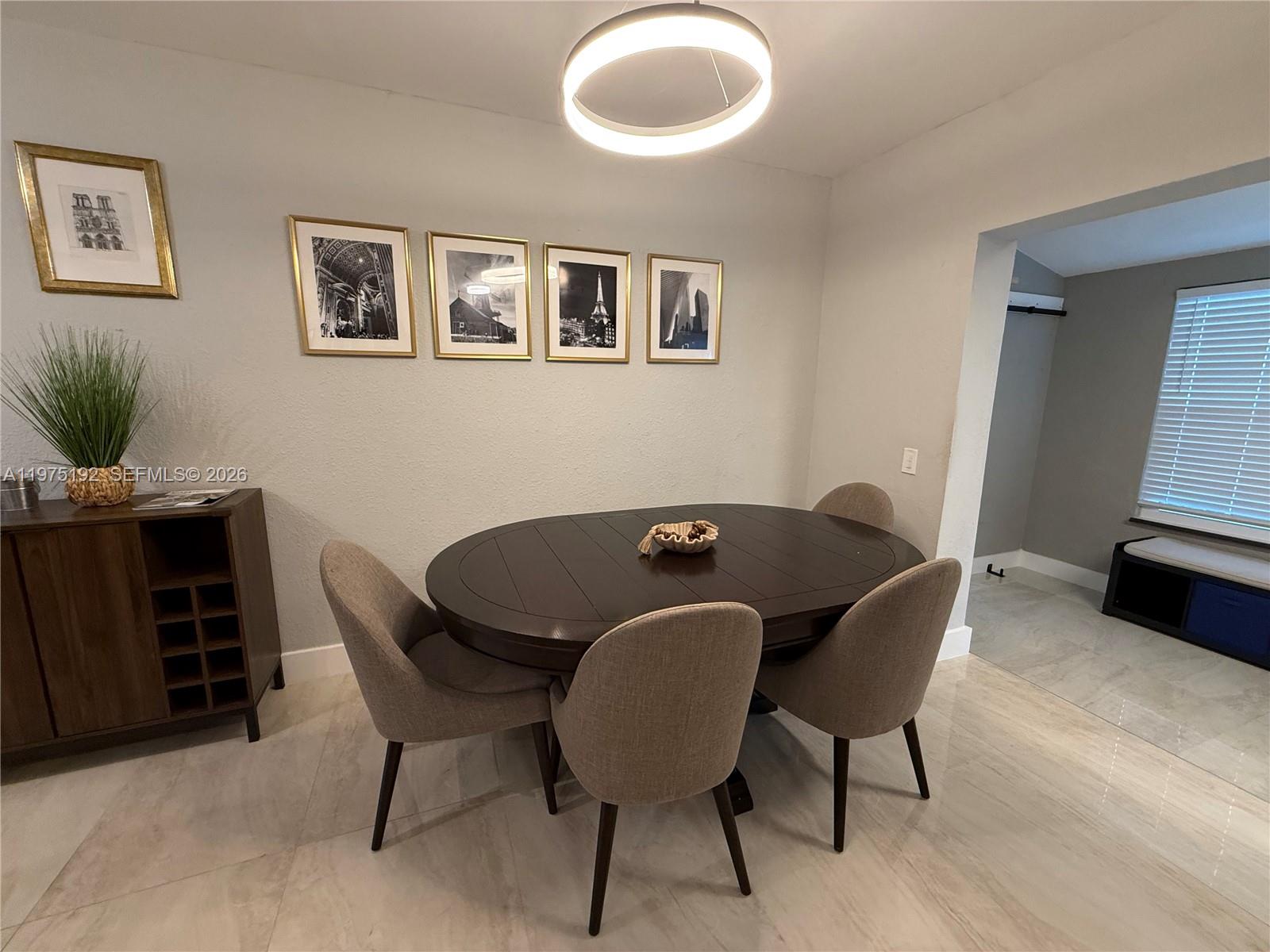4850 Southwest 4th Street Miami, FL 33134 - Photo 8 of 28 a view of a dining room with furniture and wooden floor