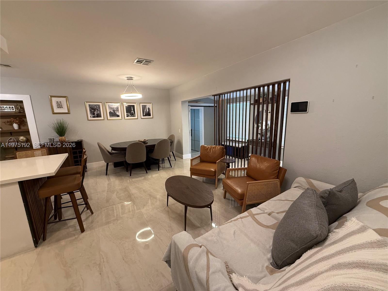 4850 Southwest 4th Street Miami, FL 33134 - Photo 9 of 28 a living room with furniture potted plant and white walls