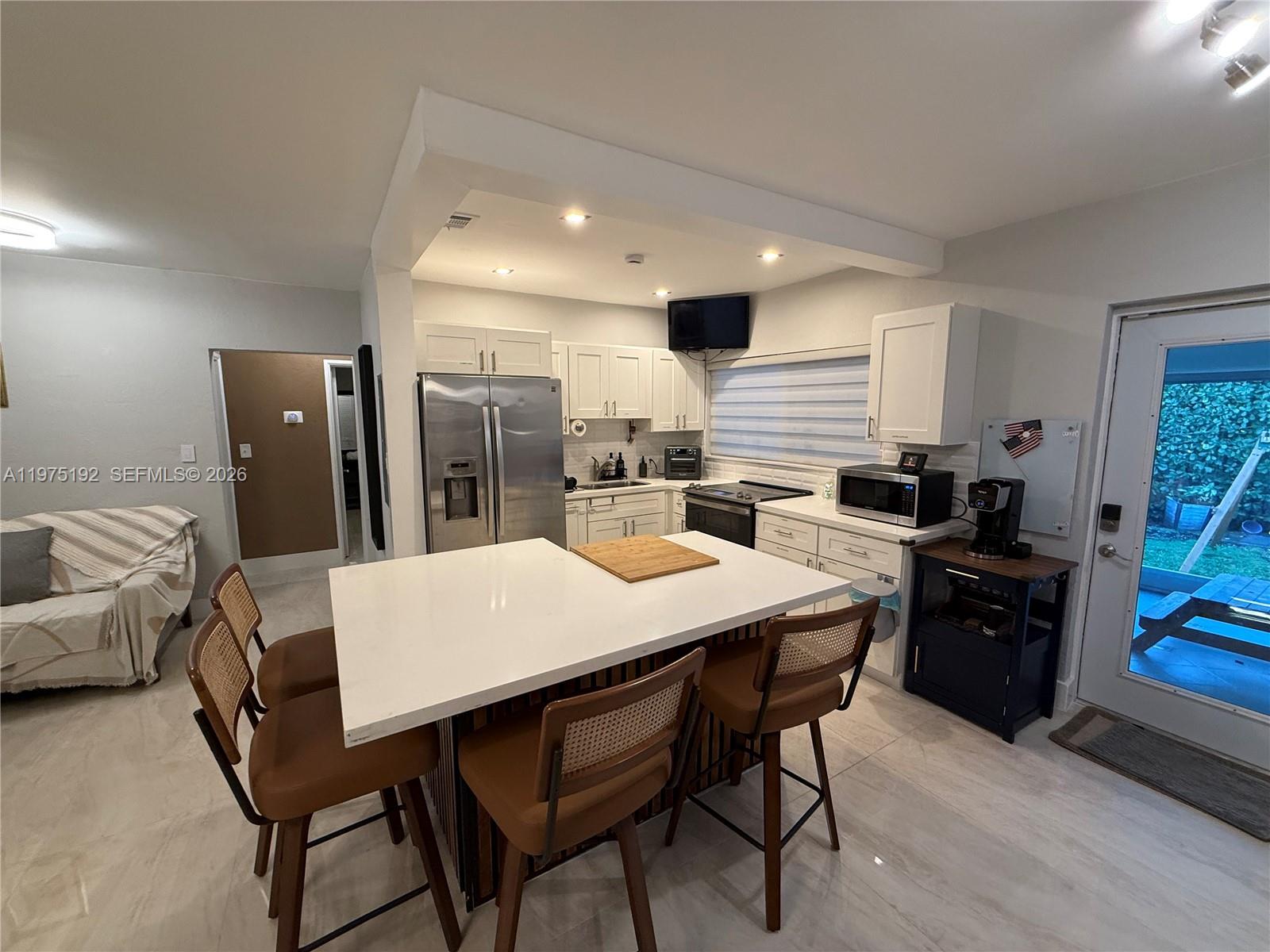 4850 Southwest 4th Street Miami, FL 33134 - Photo 10 of 28 a large kitchen with a table and chairs