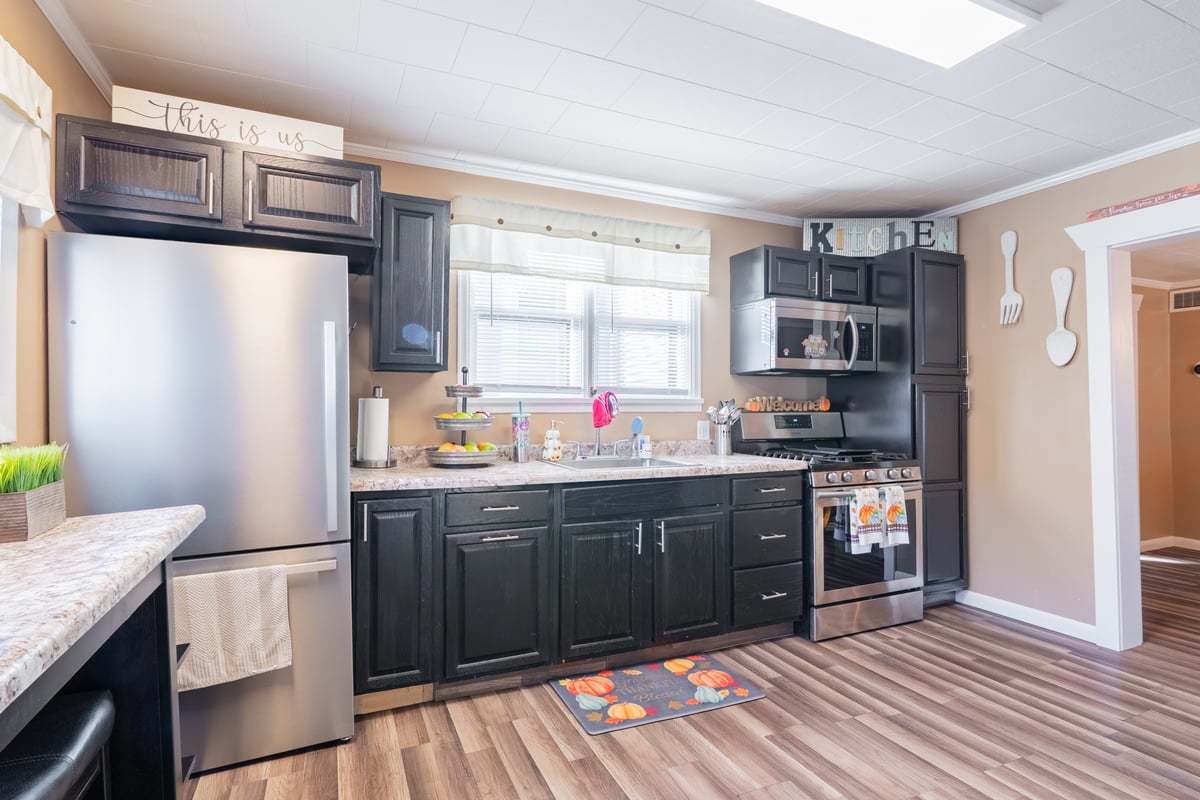 1206 East Main Street Clinton, IL 61727 - Photo 12 of 28 a kitchen with stainless steel appliances granite countertop a refrigerator and a sink