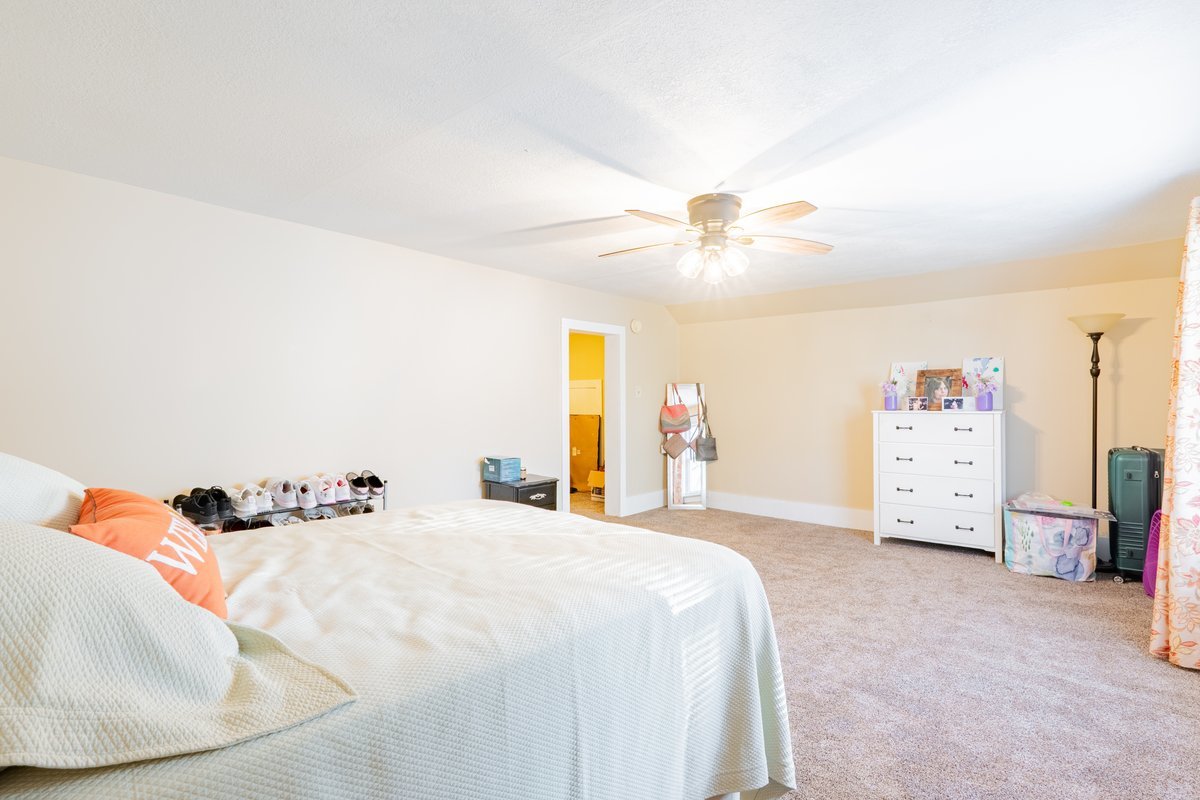 1206 East Main Street Clinton, IL 61727 - Photo 16 of 28 a bedroom with a bed and a chandelier