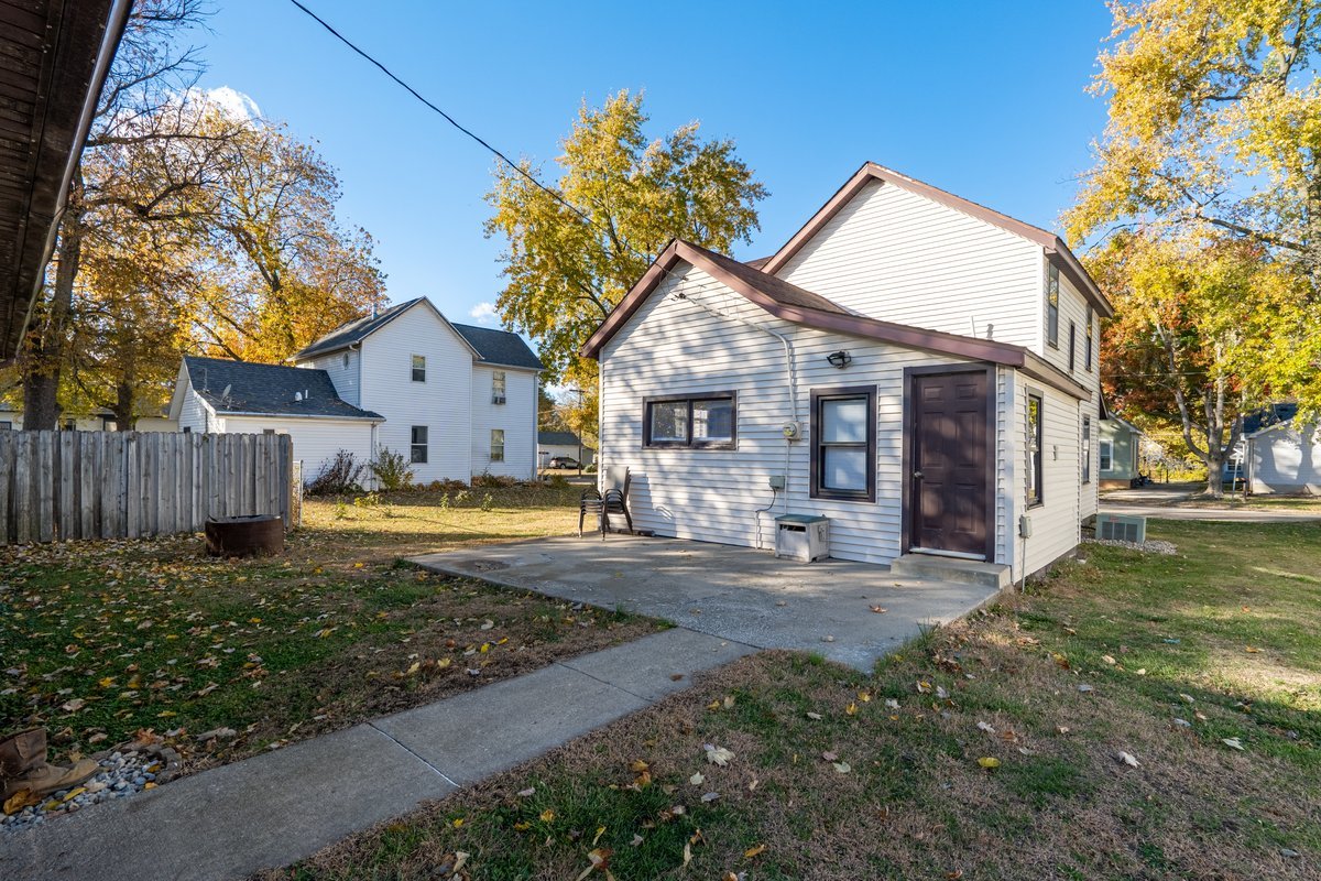 1206 East Main Street Clinton, IL 61727 - Photo 23 of 28 a view of a house with a big yard and large tree