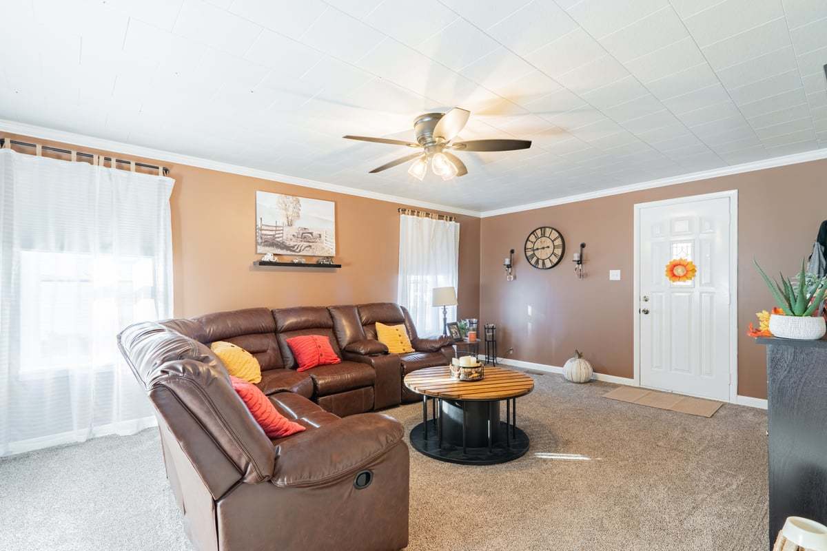 1206 East Main Street Clinton, IL 61727 - Photo 6 of 28 a living room with furniture and a ceiling fan