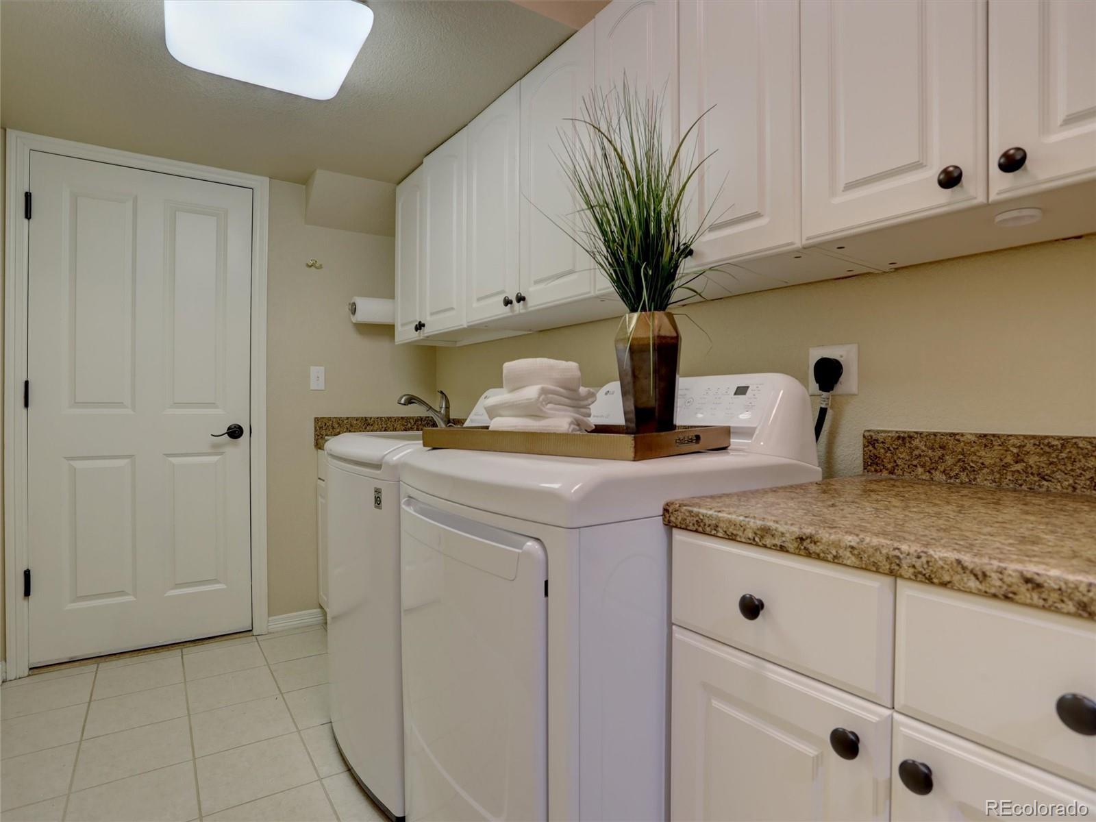 18288 East Caley Place Aurora, CO 80016 - Photo 15 of 50 a kitchen with stainless steel appliances granite countertop a sink a stove and cabinets