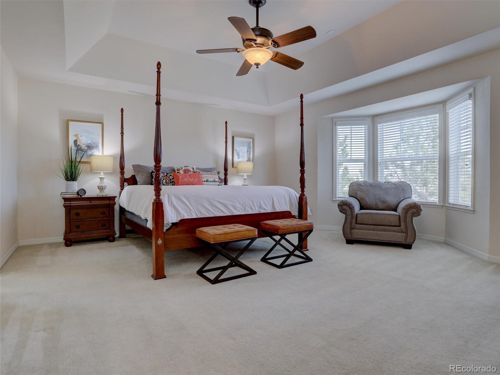 18288 East Caley Place Aurora, CO 80016 - Photo 16 of 50 a bedroom with a bed and a chandelier