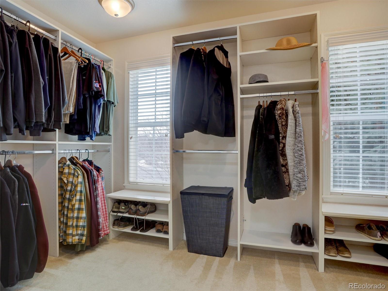 18288 East Caley Place Aurora, CO 80016 - Photo 20 of 50 a view of walk in closet with clothes and shoes