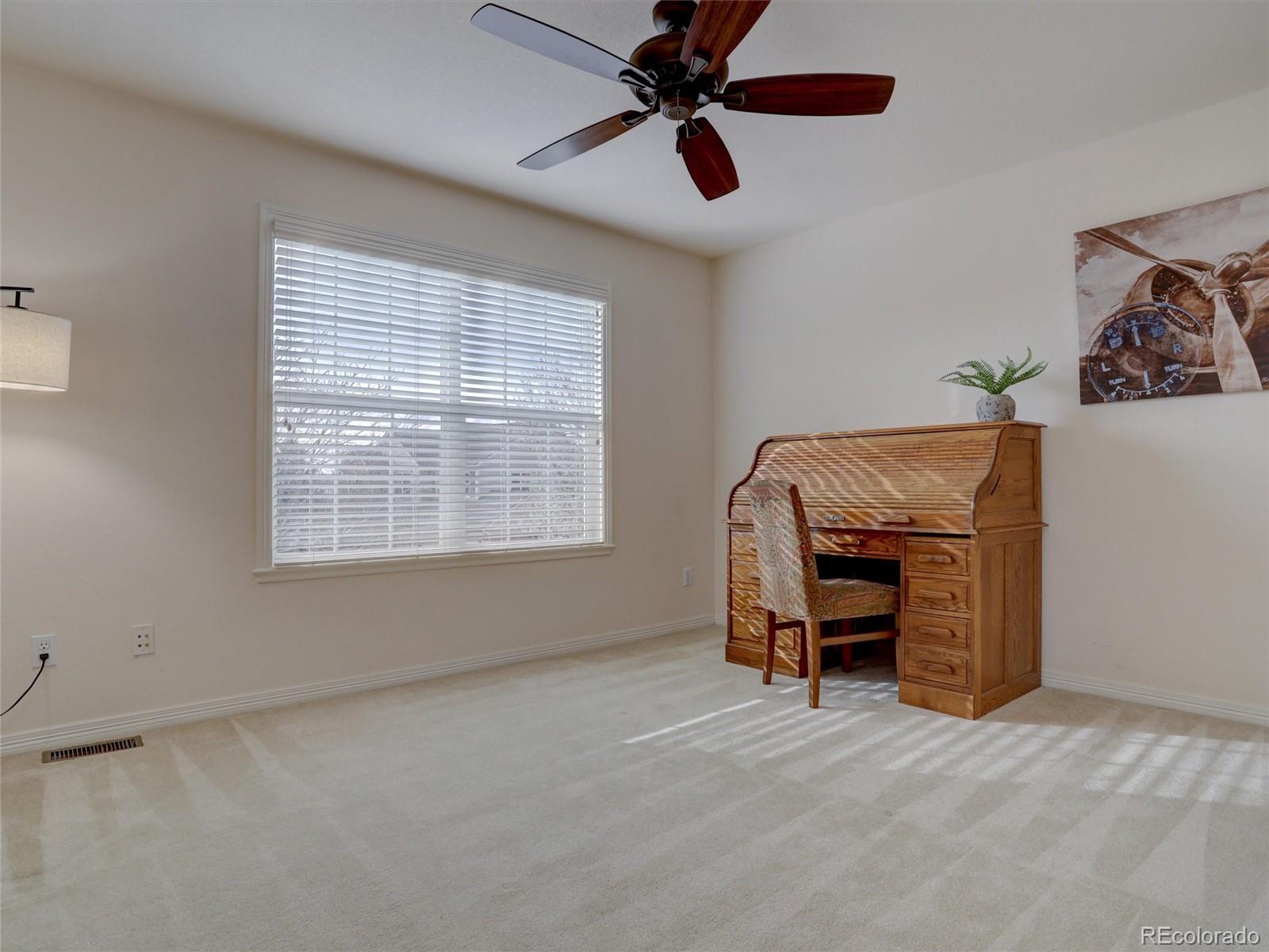 18288 East Caley Place Aurora, CO 80016 - Photo 25 of 50 a view of a livingroom with furniture and a ceiling fan