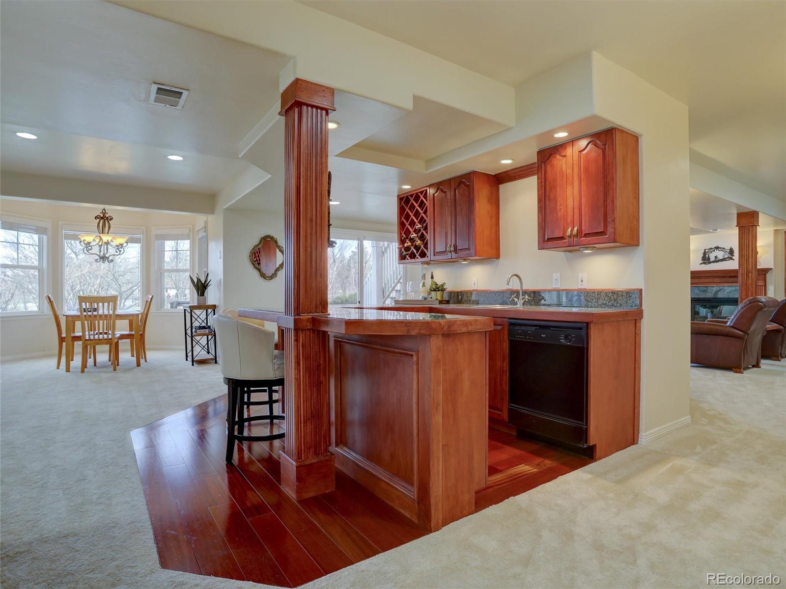 18288 East Caley Place Aurora, CO 80016 - Photo 27 of 50 a kitchen with stainless steel appliances granite countertop a stove a sink and a refrigerator