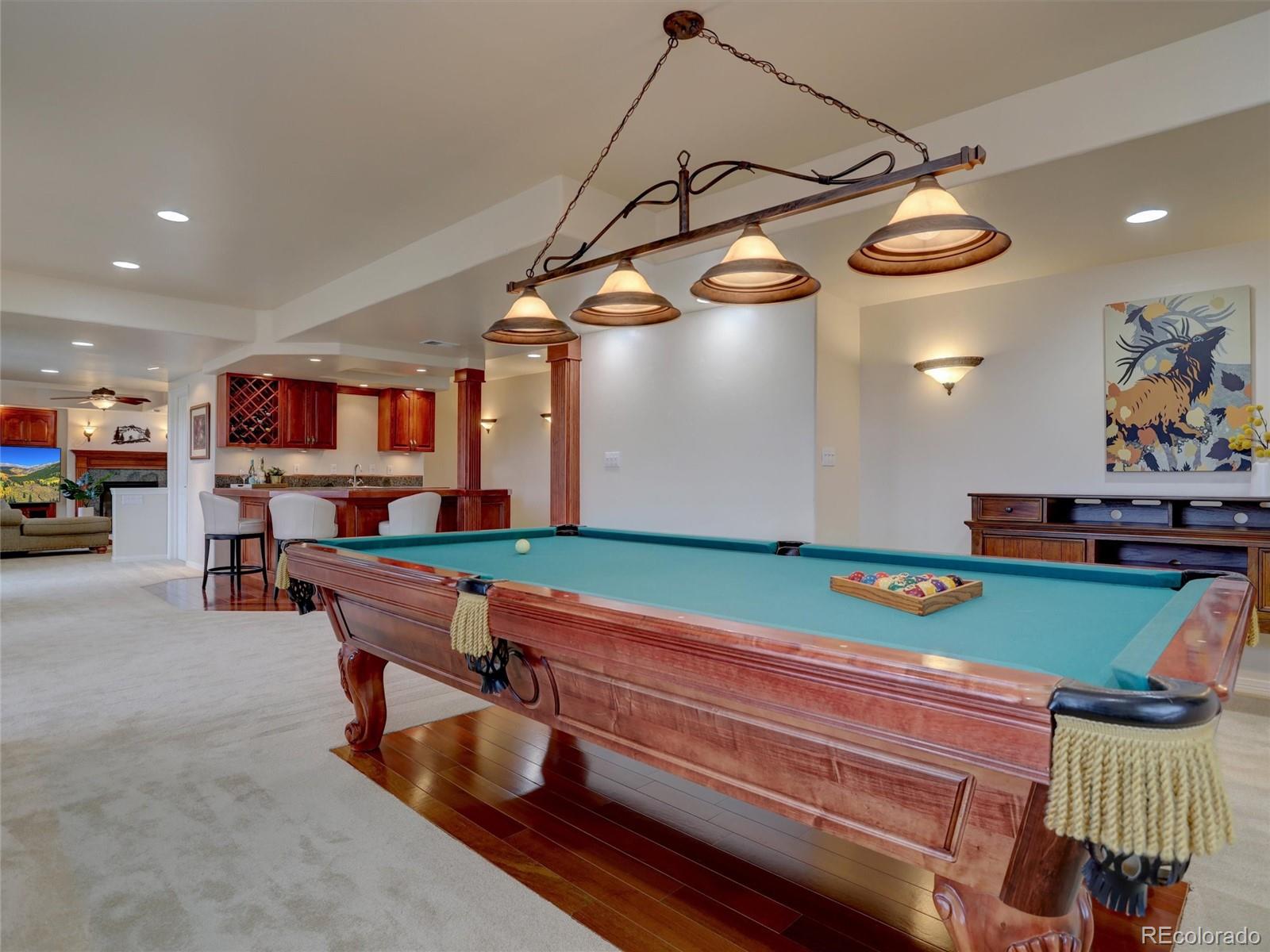 18288 East Caley Place Aurora, CO 80016 - Photo 28 of 50 a room with lots of wooden furniture and a chandelier