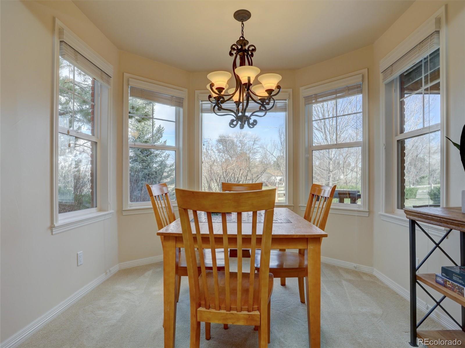 18288 East Caley Place Aurora, CO 80016 - Photo 30 of 50 a view of a dining room with furniture window and outside view