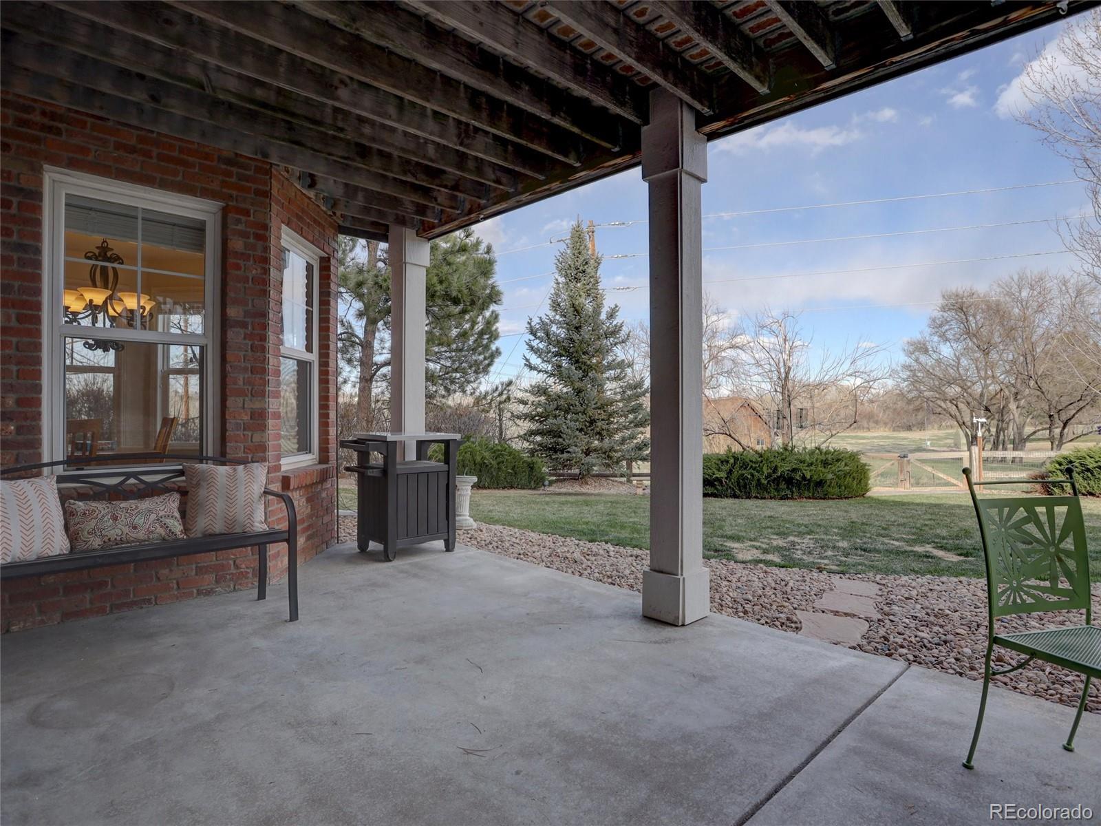 18288 East Caley Place Aurora, CO 80016 - Photo 35 of 50 a view of a porch with furniture and garden