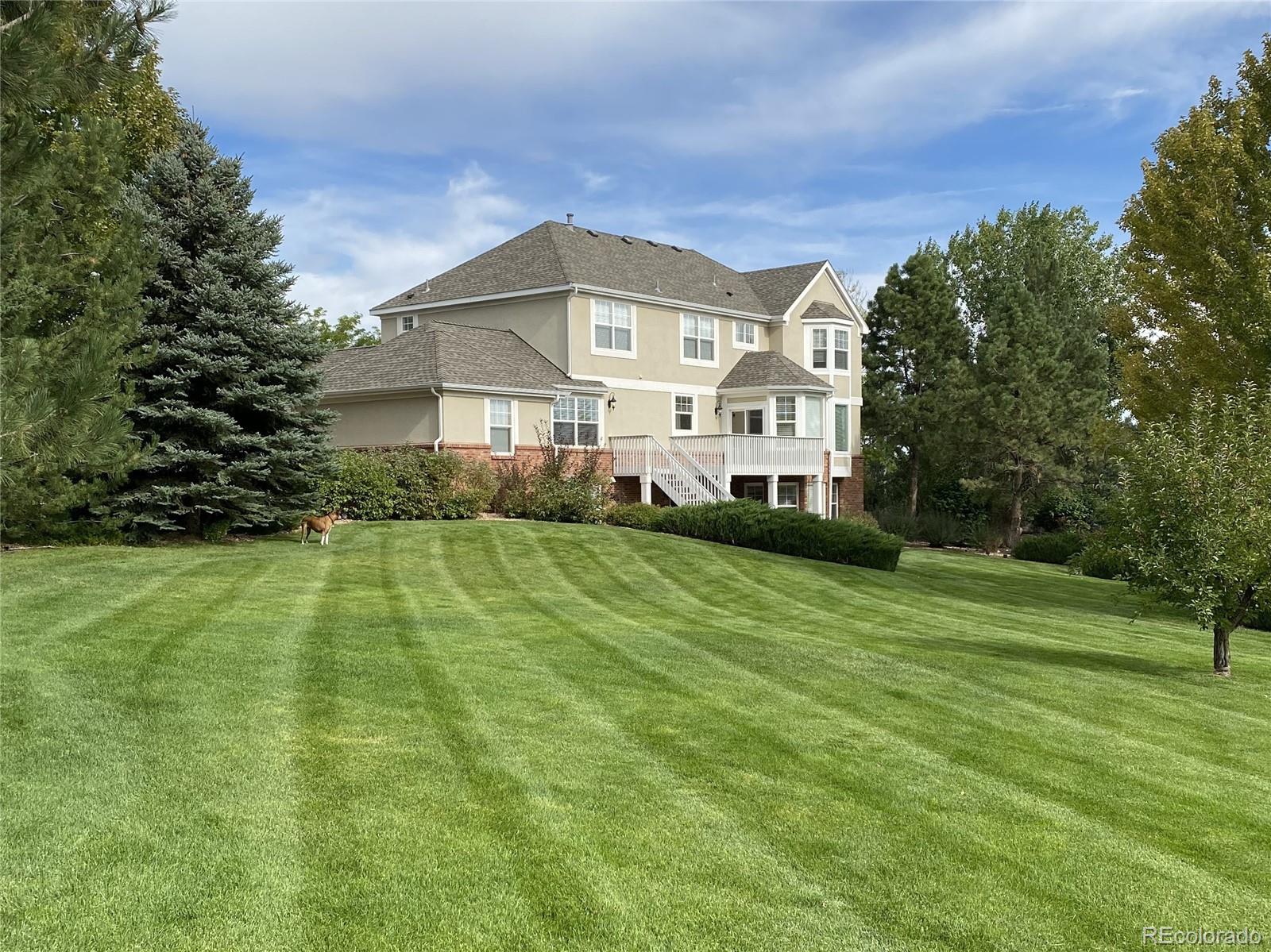 18288 East Caley Place Aurora, CO 80016 - Photo 39 of 50 a front view of a house with a yard