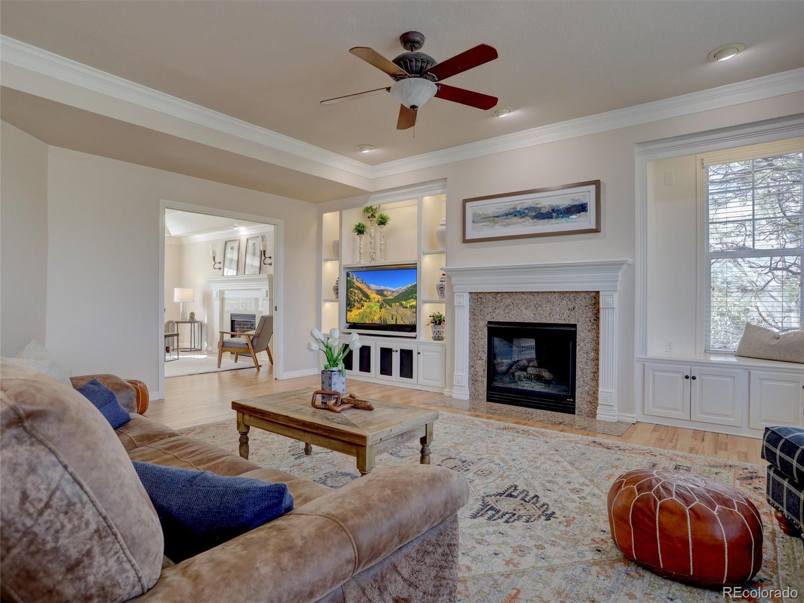 18288 East Caley Place Aurora, CO 80016 - Photo 9 of 50 a living room with furniture and a fireplace