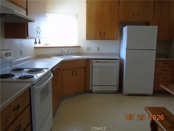 a kitchen with stainless steel appliances a refrigerator and a stove