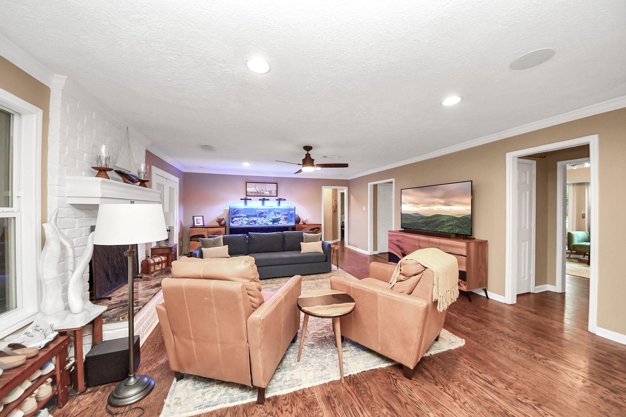 6403 Craigway Road Spring, TX 77389 - Photo 6 of 39 Spacious living room with white brick fireplace, real hardwood floors, and bright open layout