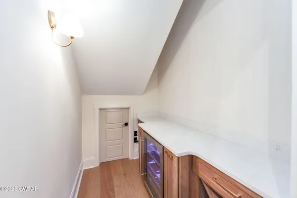 a kitchen with refrigerator cabinets and a wooden floor