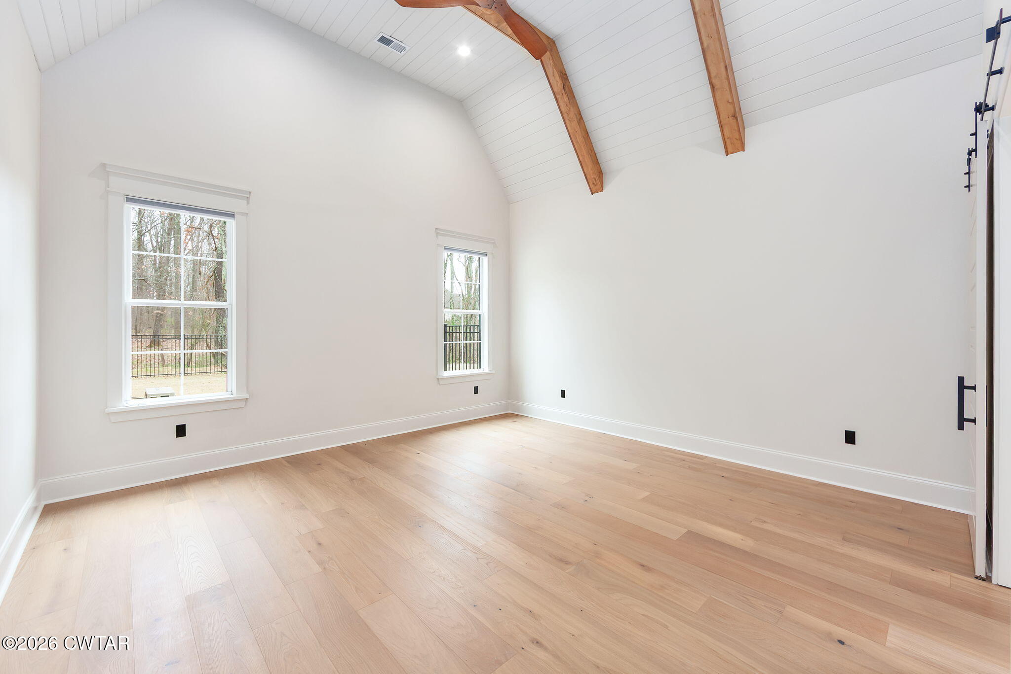 115 Buckingham Cove Jackson, TN 38305 - Photo 19 of 58 an empty room with wooden floor and windows
