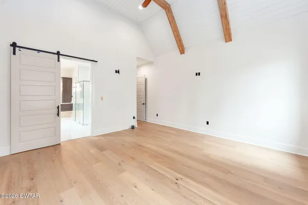a spacious bathroom with a bathtub and shower