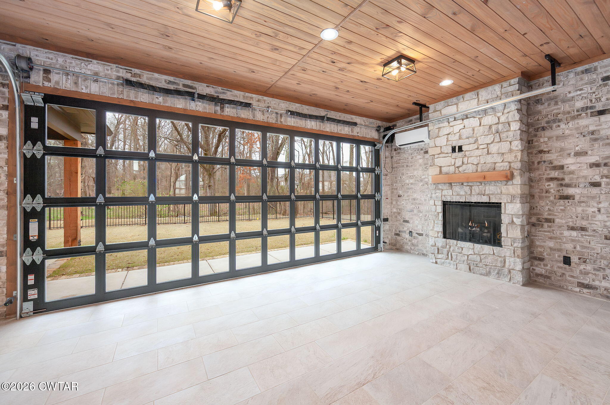 115 Buckingham Cove Jackson, TN 38305 - Photo 43 of 58 a view of an empty room with a fireplace and windows
