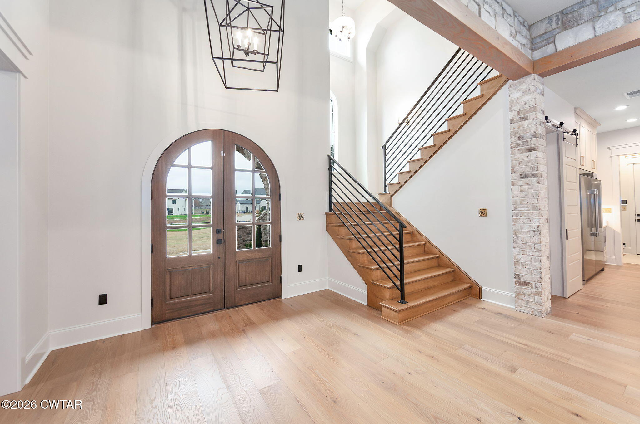 115 Buckingham Cove Jackson, TN 38305 - Photo 5 of 58 a view of a hallway with entryway wooden floor and front door