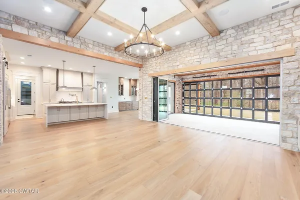 a large kitchen with stainless steel appliances a large counter top