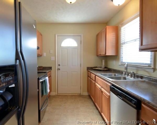 526 Riverwind Drive Spring Lake, NC 28390 - Photo 11 of 29 a kitchen with stainless steel appliances granite countertop a sink stove and refrigerator
