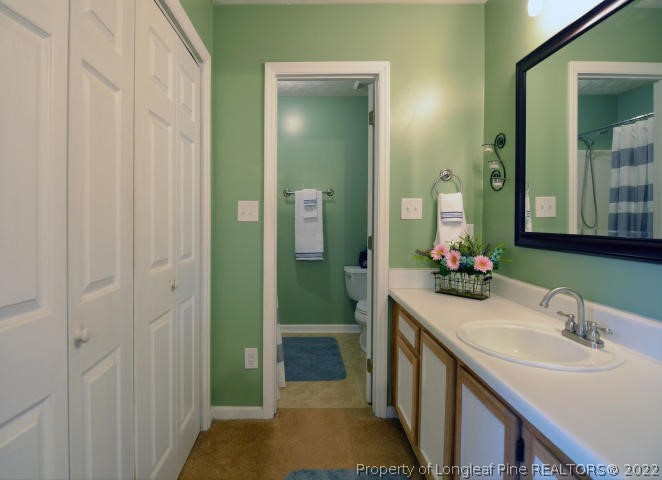 526 Riverwind Drive Spring Lake, NC 28390 - Photo 17 of 29 a bathroom with a double vanity sink and a mirror