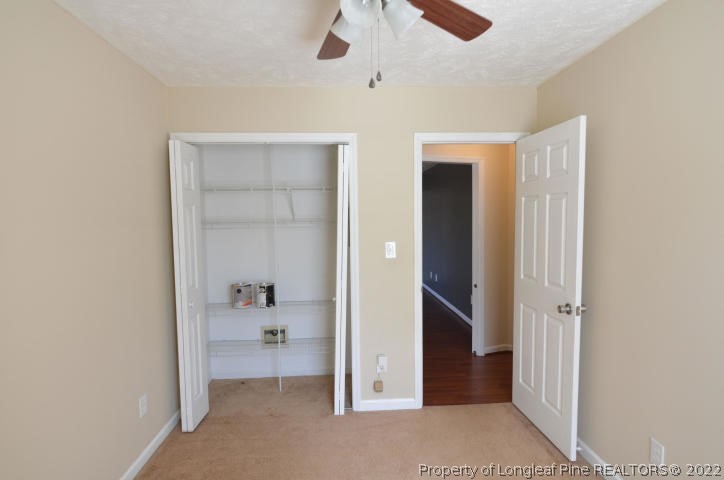 526 Riverwind Drive Spring Lake, NC 28390 - Photo 23 of 29 an empty room with an entryway and a chandelier fan