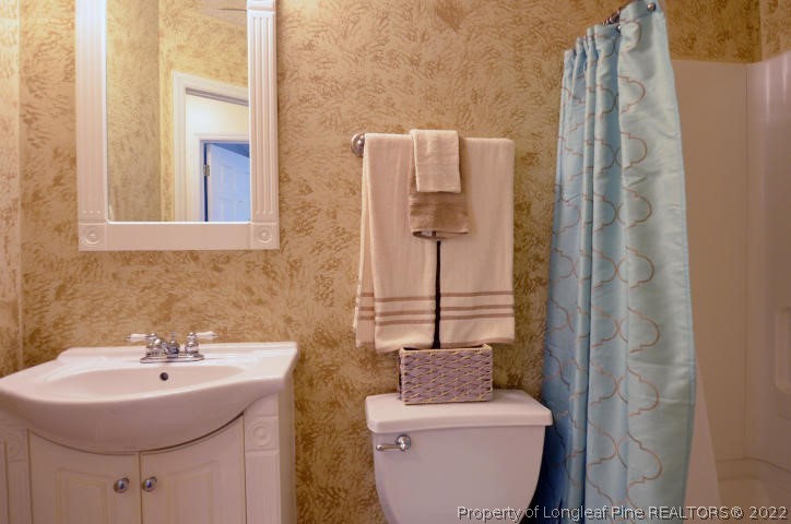 526 Riverwind Drive Spring Lake, NC 28390 - Photo 25 of 29 a bathroom with a sink toilet and shower