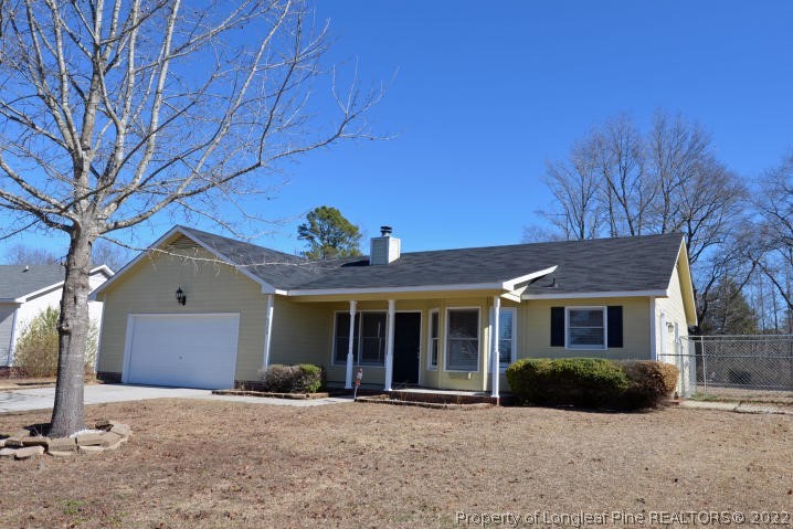 526 Riverwind Drive Spring Lake, NC 28390 - Photo 3 of 29 a front view of a house with a yard and garage