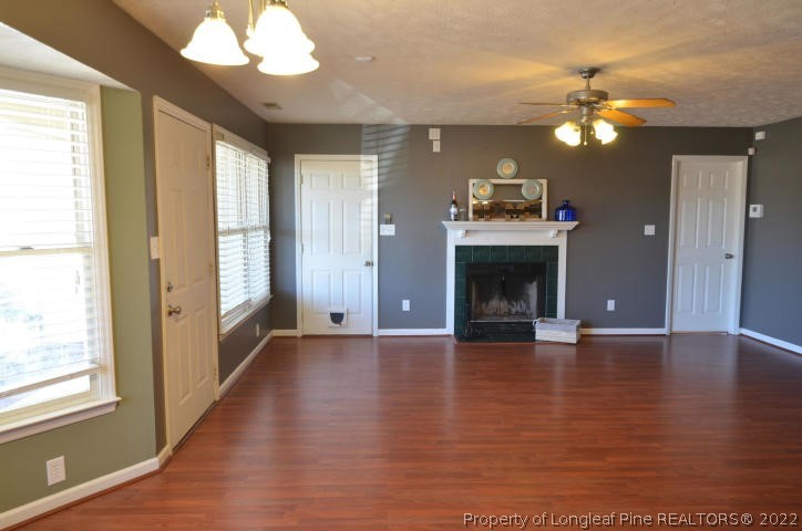 526 Riverwind Drive Spring Lake, NC 28390 - Photo 6 of 29 a view of a livingroom with a fireplace wooden floor and chandelier