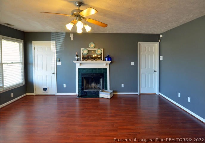 526 Riverwind Drive Spring Lake, NC 28390 - Photo 7 of 29 an empty room with wooden floor fire place and windows