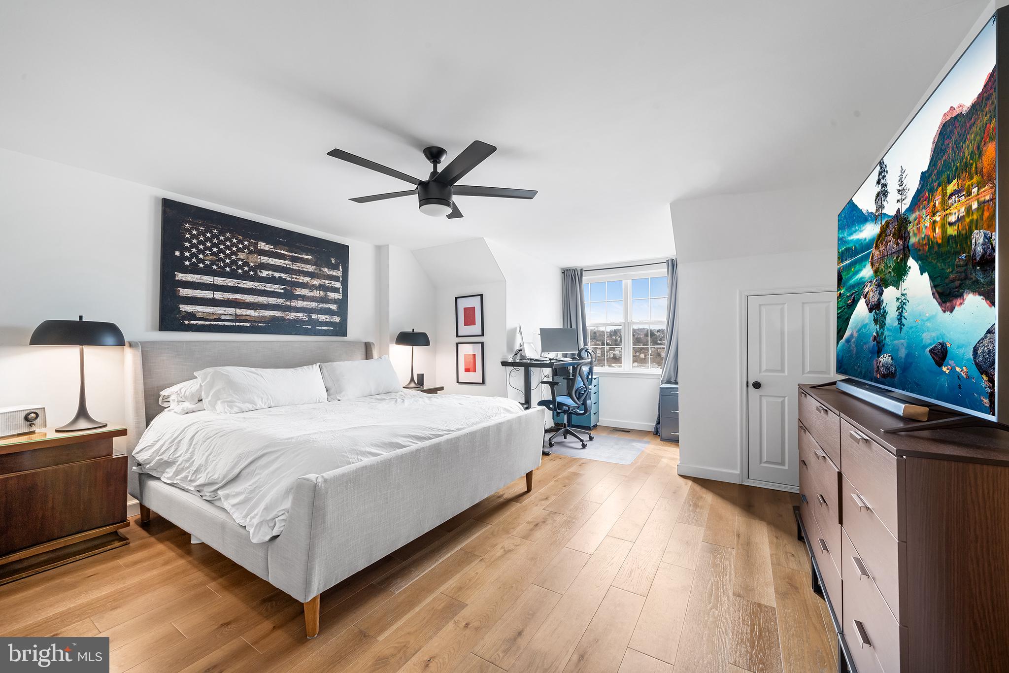 243 Ripka Street Philadelphia, PA 19127 - Photo 17 of 31 a spacious bedroom with a bed and a flat screen tv