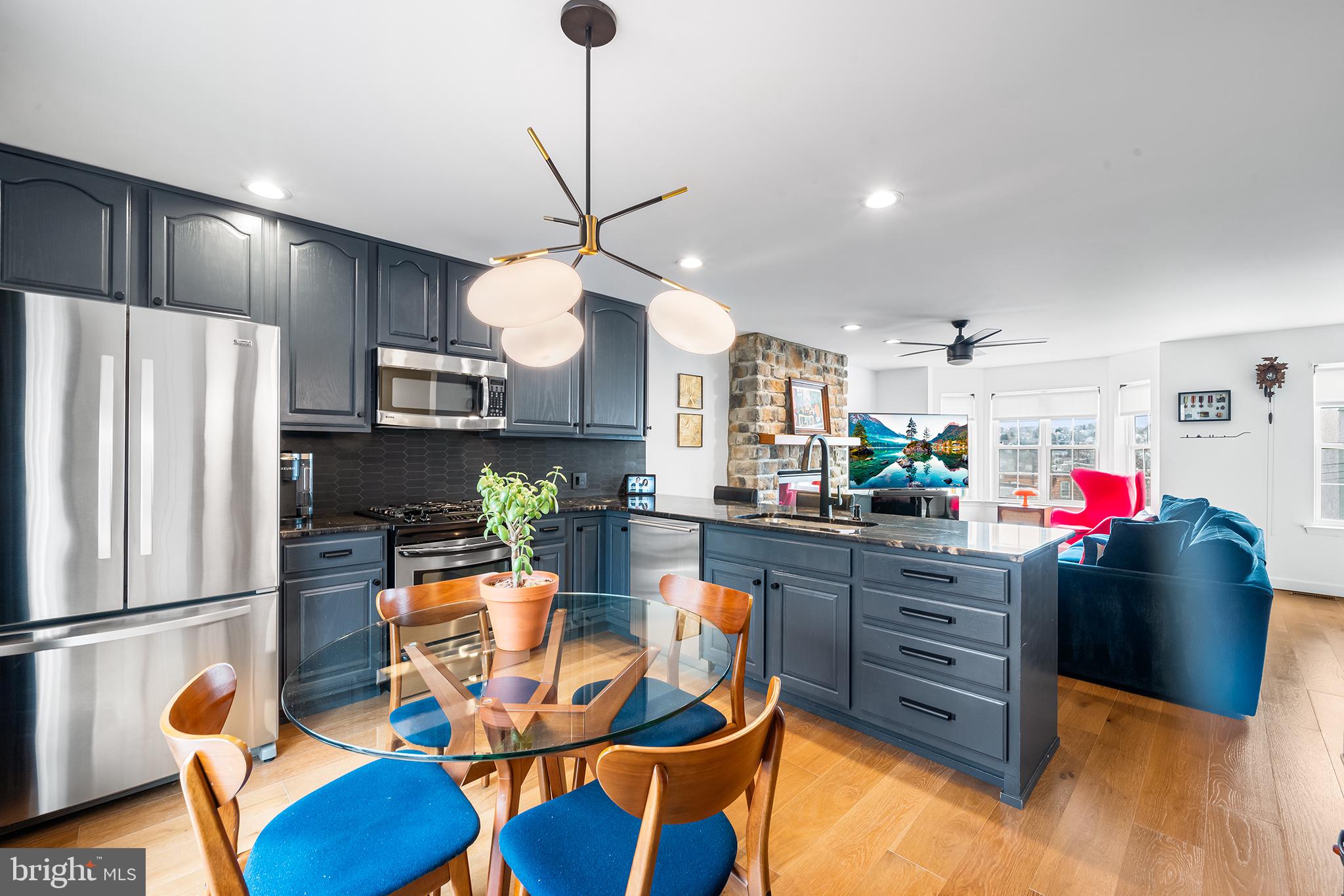 243 Ripka Street Philadelphia, PA 19127 - Photo 3 of 31 a kitchen with stainless steel appliances kitchen island granite countertop a refrigerator and microwave